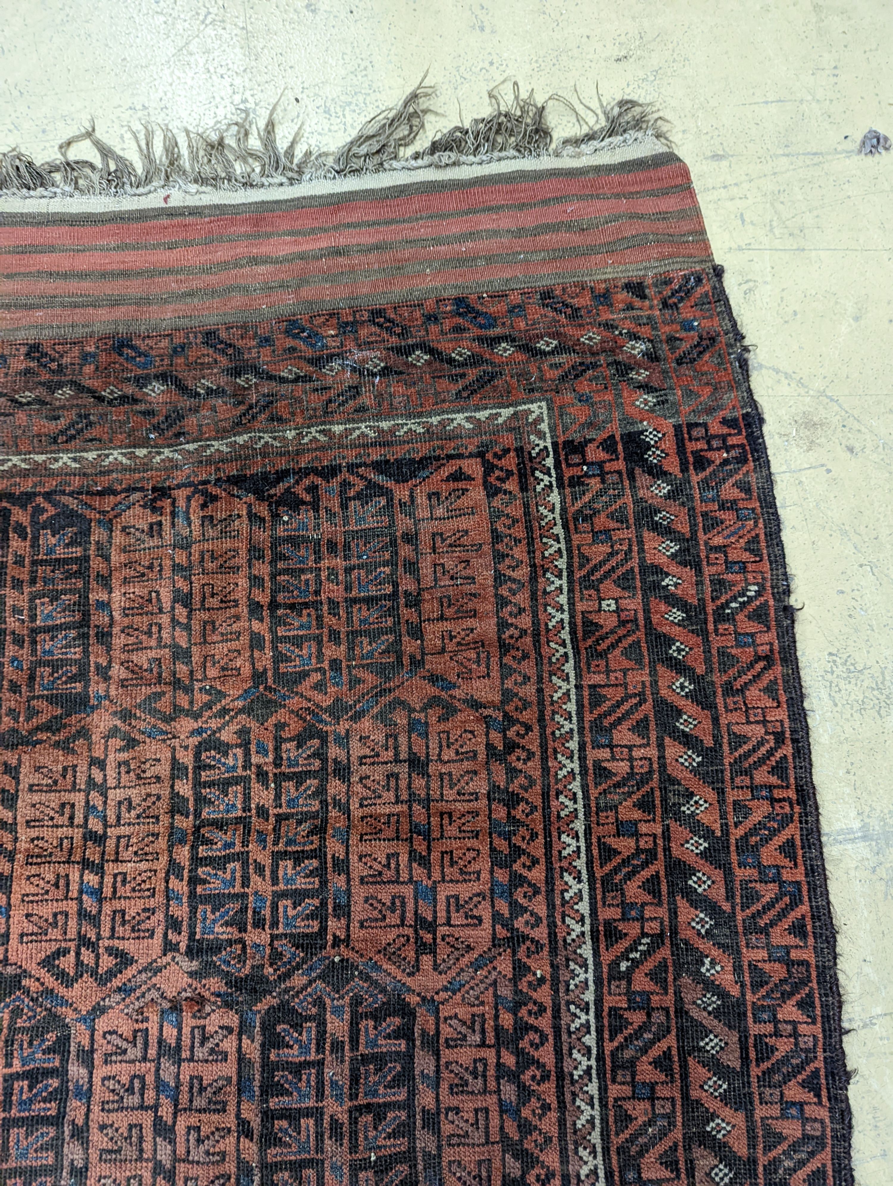 A Belouch red ground rug and a prayer rug, largest 178 x 106cm